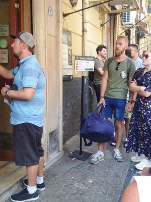 Take away line, you have to be careful, if you get into the wrong line, you have to go to the end of the right line and wait all way long again at Pizzeria da Michele in Naples