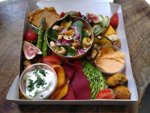 Vegan tapas take out box. Freshly baked bread in a separate paper bag. at Cafe Sprød in Soenderborg