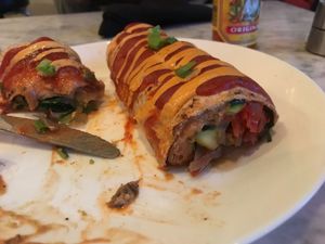 Vegan bean and veggie enchiladas with an almond cheese sauce at Frida's in University City