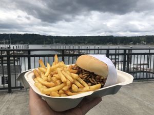 Eating on a bench by the water  at Juicy J's Smoked Burgers in Poulsbo