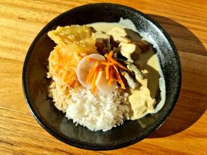 Rice bowl with tofu green curry and extra veggie Tempura and housemade pickles. at Cookatoo Kitchen in Richmond