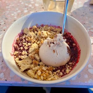 warm wild berry crumble with speculoos brownie ice cream 😋  at enila plant based ice cream in Basel