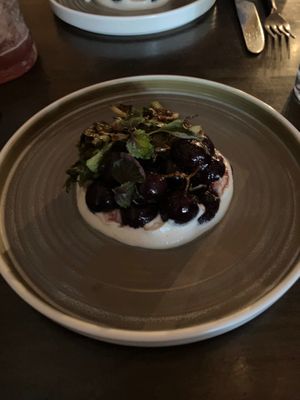 Cooked Concord grapes with cashew yogurt and Brussels sprouts leaves at Hawker in Toronto