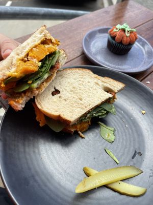 Pumpkin sandwich 🥪 it’s good + the Halloween themed cupcake    at Scullin Sweet Bones in Belconnen