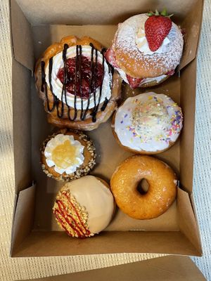 cherry fritter, strawberry shortcake, apple walnut, vanilla birthday cake, pbj, & original glazed  at Rock N Roll Donut Bar in Monterey