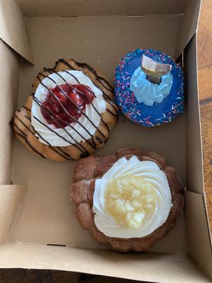 Clockwise:  Cherry fritter, mermaid’s tail, and apple fritter    at Rock N Roll Donut Bar in Monterey