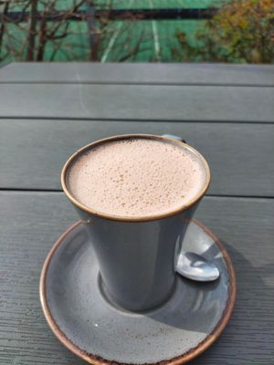 Vegan hot chocolate on sunny terrasse at Pool Cafe in Hathersage