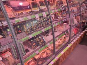 Refrigerated counter with labeled vegan products at EkoPlaza - Elandsgracht in Amsterdam