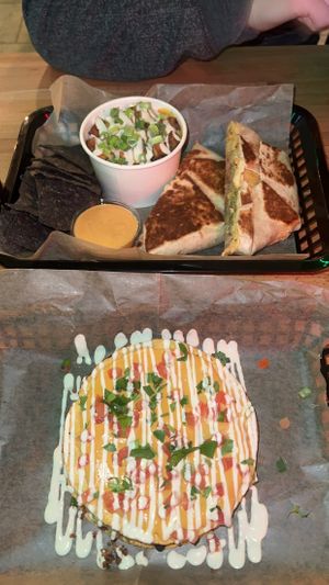 crunchwrap with jackfruit, bodega potatoes, & side of queso. mexipie tostadas.   at JDs VegMex in Miami