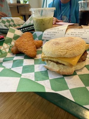 Sausage Egg and Cheese sandwich with Hash browns and matcha latte   at elephant+vine in Chicago