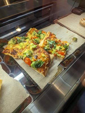 Filling pizza with thick fluffy base and vegan cheese at Cristina's kitchen in Mechelen