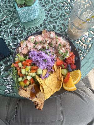 Think this was some sort of rice bowl w/ spicy sausage, samosa, tortilla crisps, salad, fruit etc  at The Chakra Lounge in Bakewell