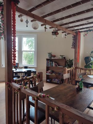 Upstairs seating area with books and games at The Chakra Lounge in Bakewell