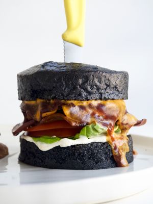 Smoked BBQ Burger. Homemade charcoal brioshe bun, special patty, fresh veggies with V'acon and rustic potato wedges at We Cafe - Maybe closed in Cape Town