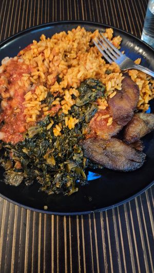 Vegan jollof rice, vegan spinach stew with beans, and plantains  at The Village PVD in Providence