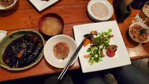 Left is eggplant with ginger sauce, on the right is the dinner set with miso soup, vegetables and rice bowl at Mominoki House in Tokyo