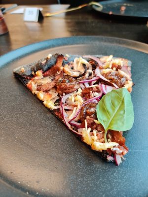 Slice of delicious pizza. at Black Crust Pizzeria in Vik