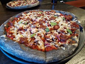 Homemade date pesto, red onion, mushroom, fresh basil, vegan mozzarella & pulled BBQ soy mince #Veganuary at Black Crust Pizzeria in Vik