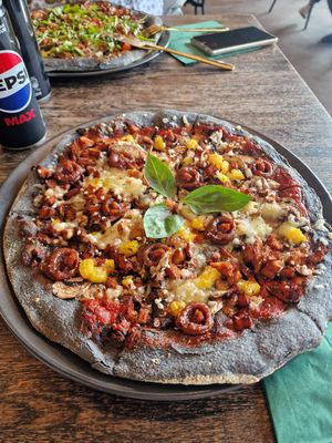 Vegan Black Crust pizza, no onion, changed for orange at Black Crust Pizzeria in Vik