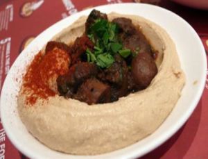 hummus and warm pitta bread with stewed button mushrooms and caramelized onions at Hummus Bros  Soho in London