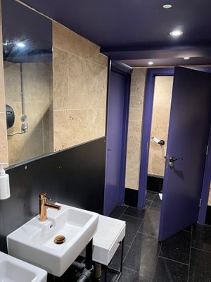 Purple women’s bathroom at Tendril in London