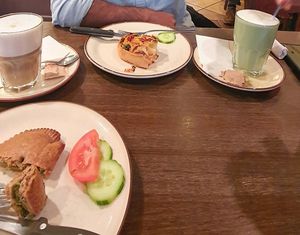Pizza type and feta pice, matcha latte and macciato latte at Holzbackerei Bio Andreas in Basel