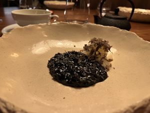 Daikon, shaved truffle, charcoal-colored risotto  at Encanto in Lisbon