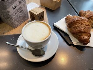 Soy cappuccino and vegan brioche filled with orange jam  at T-Bakery in Bergamo