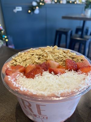 A build-your-own smoothie bowl topped with shredded coconut, strawberries, and granolaa  at BARE Blends in Latham