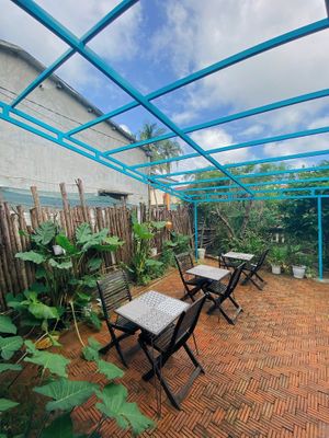 Outdoor seating with garden and sky view ☁️   at Chickpea Eatery Thuan Chay in Hoi An