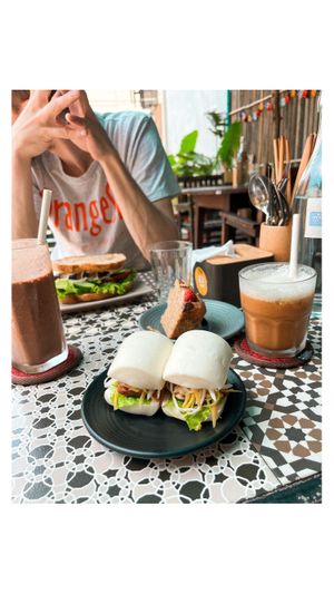 Banh bao, banana bread, chocolate+peanut butter+banana smoothie, iced coffee with soy milk and sandwich 🤍  at Chickpea Eatery Thuan Chay in Hoi An