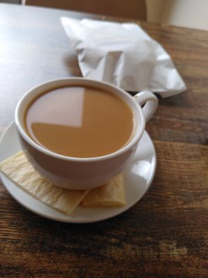 Sausage roll to go and Americano with oat barista milk. at The Delightful Touch in Sheffield