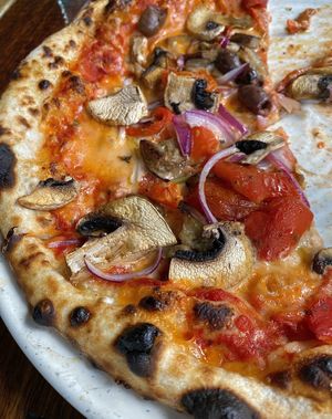 Vegan pizza. Missing the artichokes as they had none, but still delicious nonetheless (you can tell by the half eaten pizza😅).  at In Forno in Hamilton