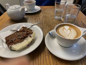 Carrot cake, oat flat white and a earl grey in the background  at Lowdown Coffee in Edinburgh