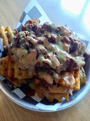 Loaded waffle fries topped with BBQ jackfruit and a bunch of sauces at Twisted Plants in Milwaukee