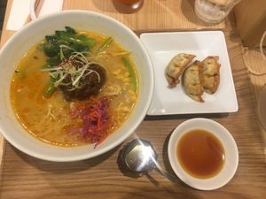 White-sesame ramen with gyoza at T's Tantan - Tokyo JR Station in Tokyo