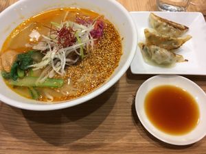Golden sesame tantan noodles with a side of gyoza at T's Tantan - Tokyo JR Station in Tokyo