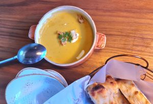 Pumpkin cream soup, served with bread at Lazy Farmers in Seoul