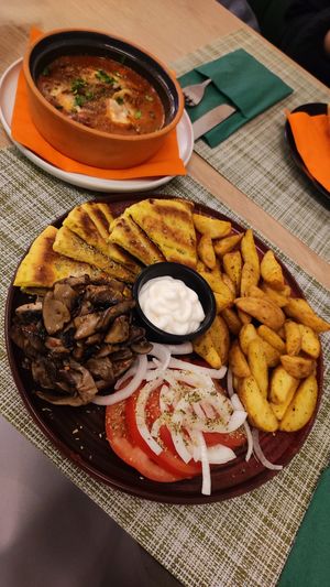 baked vegan feta and aubergine on top, gyros plate with mayo at the bottom at Veganissimo in Santorini