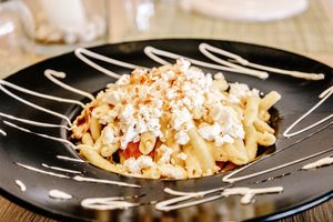 Hand made Cretan pasta with vegan feta , dried tomatoes , capers at Veganissimo in Santorini