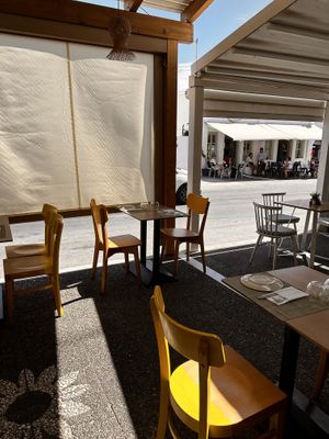 Outdoor seating next to main road   at Veganissimo in Santorini