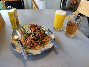 The fried noodle, pineapple juice and welcoming tea at Thong Dong Vegan Kitchen & Cafe in Lao Cai