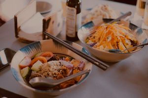 mixing rice and salad at Thong Dong Vegan Kitchen & Cafe in Lao Cai