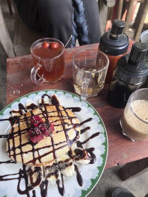 Vegan pancakes, ginger tea with dried apple  at Thong Dong Vegan Kitchen & Cafe in Lao Cai
