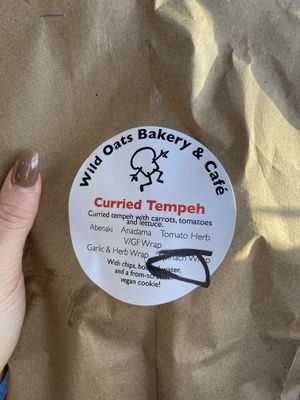 Curbside vegan bagged lunch! I chose the curried tempeh wrap. Comes with chips, vegan chocolate chip cookie, and a bottle of water. at Wild Oats Bakery and Cafe in Brunswick
