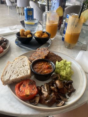  Vegan breakfast with sweetcorn fritters, sourdough , home made beans, tomato, mushrooms with a side of mini hash browns   at The Skinny Kitchen - Eivissa in Ibiza