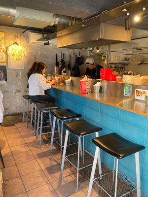 Some chairs at the bar and there are a few on the left out of view.  at Qué Pasa - Downtown in Kyoto