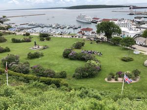 The view from our porch table Uber a bright yellow umbrella   at Fort Mackinac Tea Room in Mackinac Island