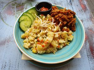 Veganized sarapan nasi, egg is exchanged for baked tempeh. Krupuk could be exchanged for cassave chips but was not available that day.  at Meisje Koffiegeschenk in Enschede