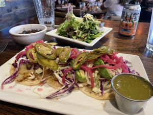 Seared Cauliflower Tacos with a side Rod salsa verde. Side salad shown in background    at Crave Kitchen & Bar in El Paso